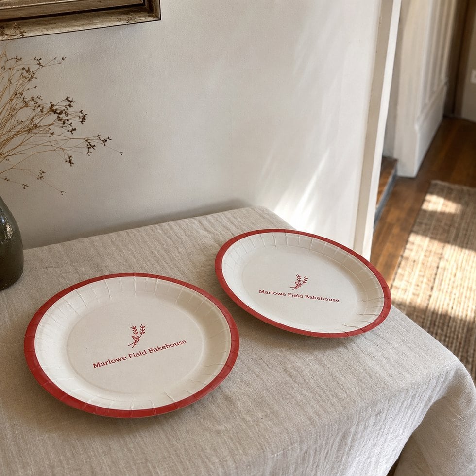 Branded paper plates arranged for an event